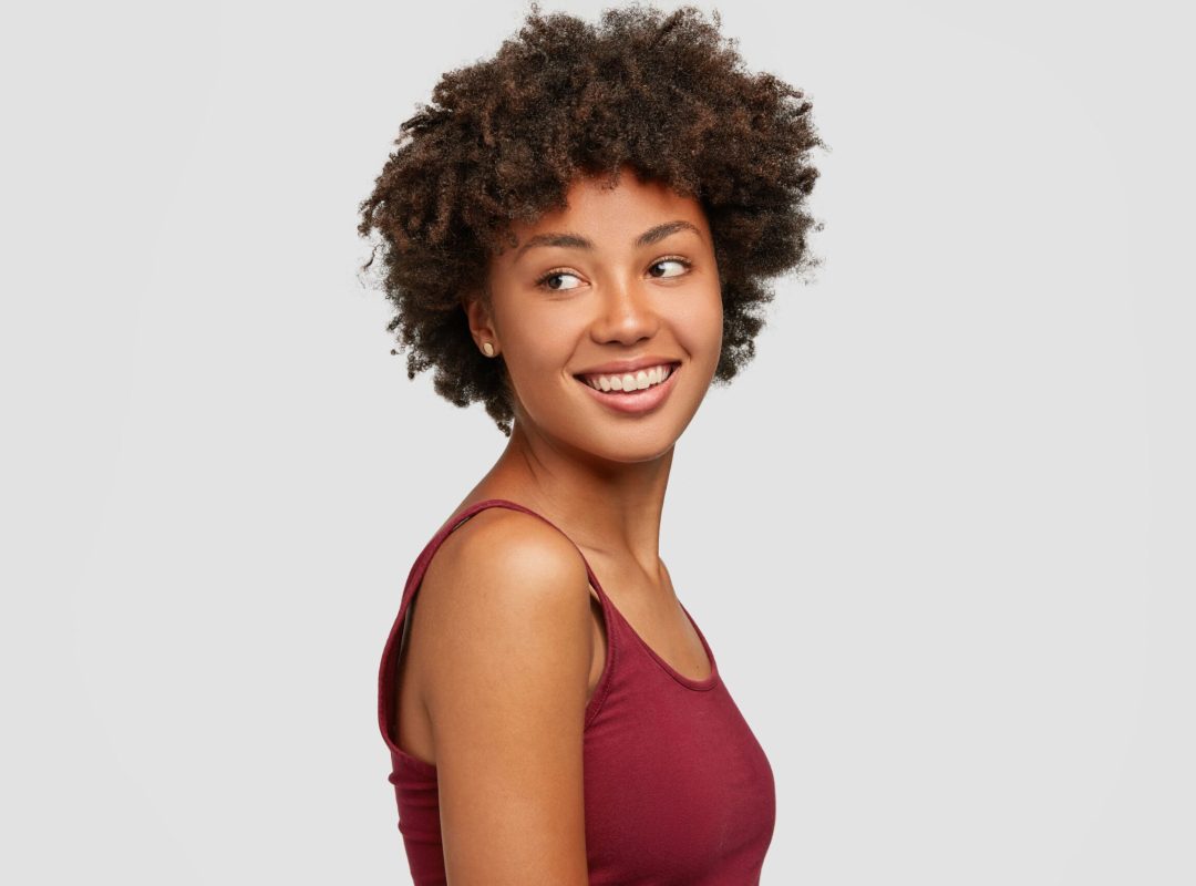 sideways-shot-pleased-relaxed-woman-with-healthy-dark-skin-looks-positively-aside-2-scaled.jpg